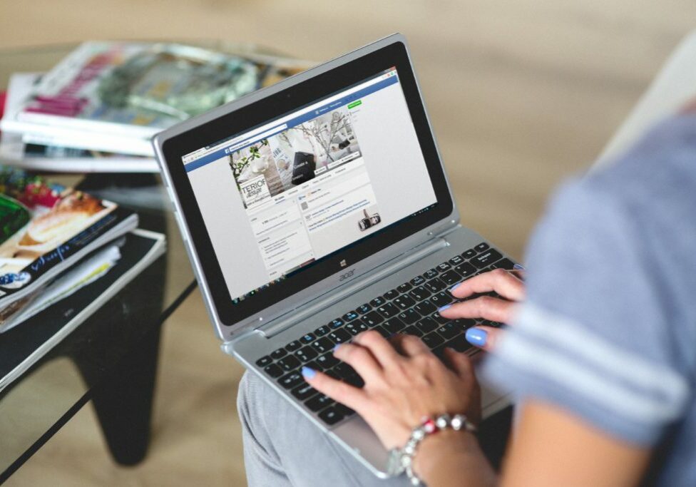 Woman managing a business facebook page from laptop